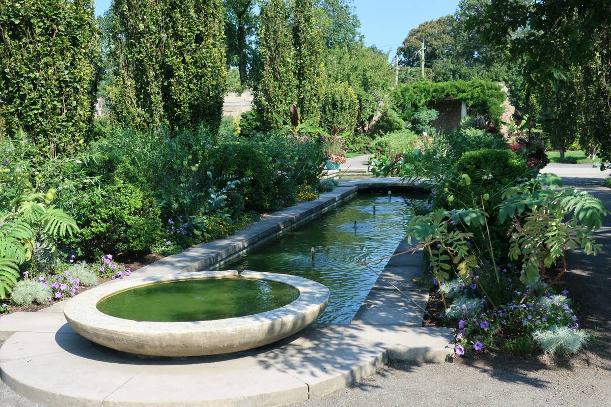 how to build a garden pond with measuring tape and liner laid beside excavated hole